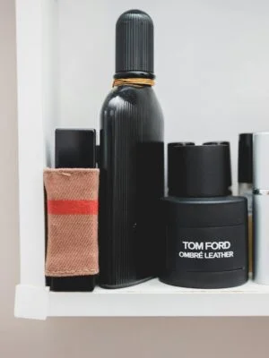 Stylish collection of designer perfumes on a shelf, showcasing luxury and elegance.